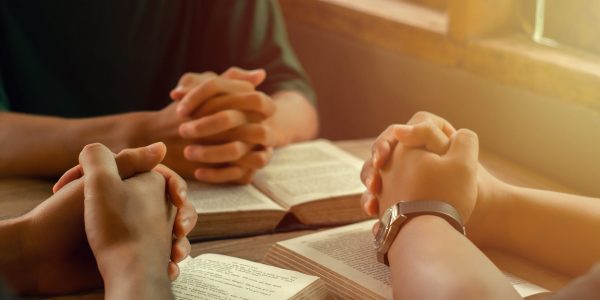 Christians join a group of cells that come together to pray and Christians join a group of cells that come together to pray and seek the blessings of God. with bible and share the gospel with copy space near the window sill in the morning